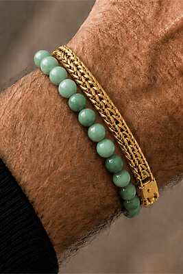 Jade green bead bracelet paired with a gold mesh bracelet on a masculine wrist.