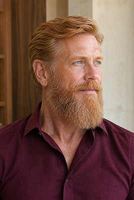Handsome mature man wearing a full, carefully shaped beard