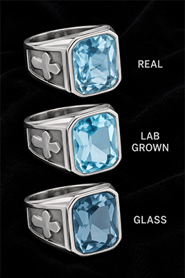 Men's aquamarine and diamond rings on black velvet depicting quality of different linds of aquamarines and diamonds.